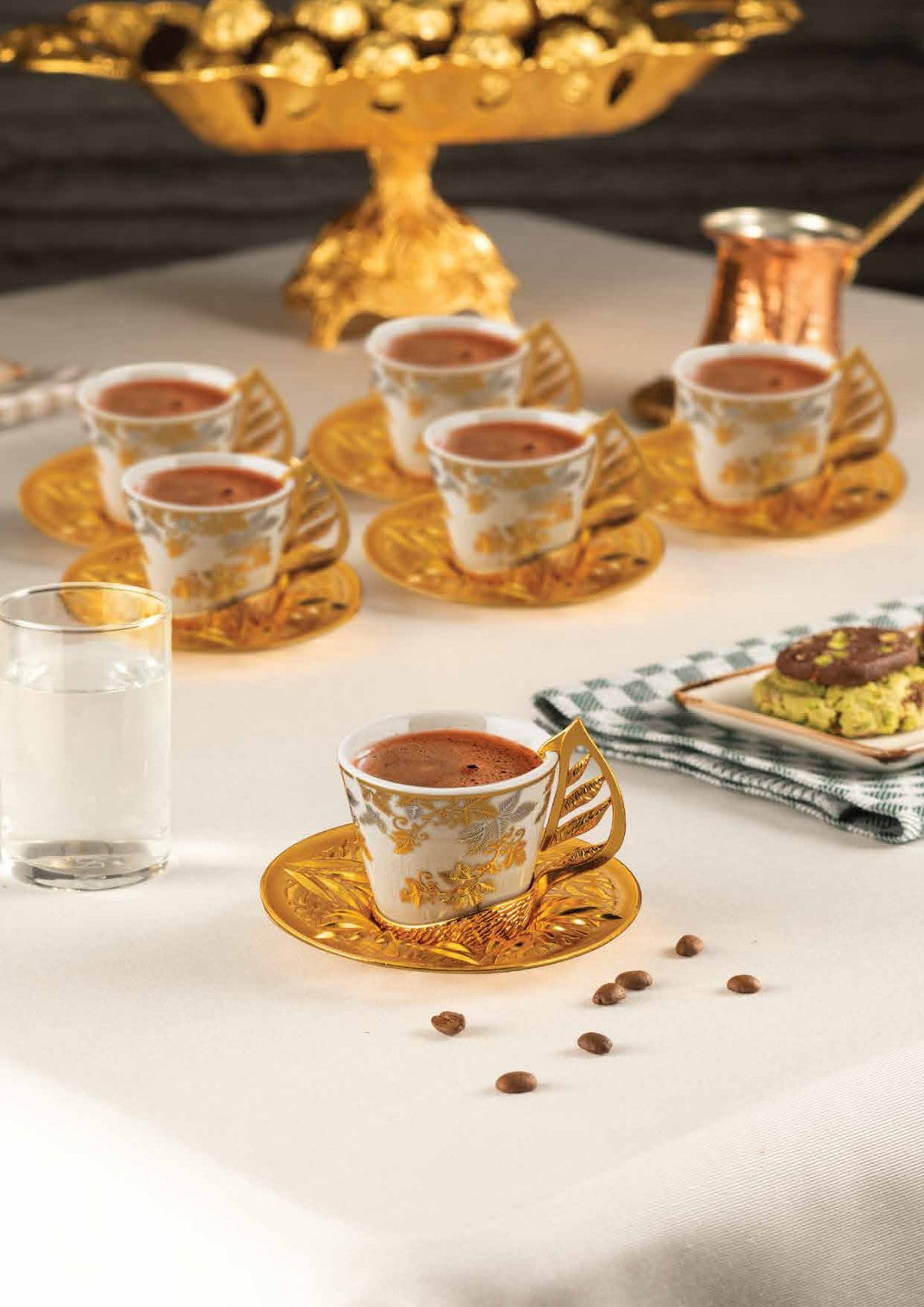 Decorative coffee service and tiered serving pieces arranged on a table
